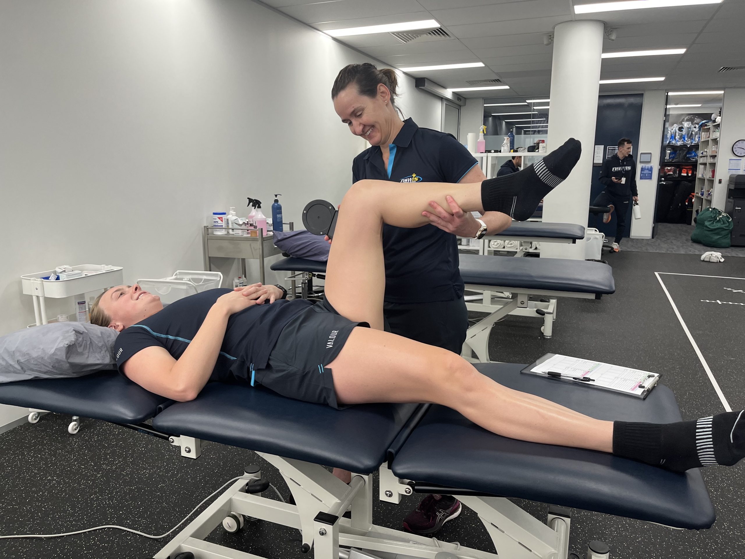 NSWIS physio Bernie Petzel with NSWIS water polo player. 