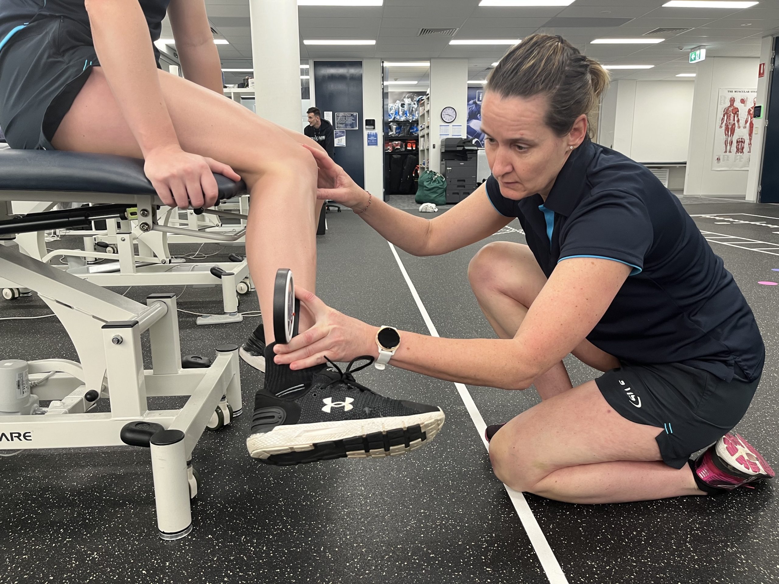 NSWIS physio Bernie Petzel with NSWIS water polo player. 