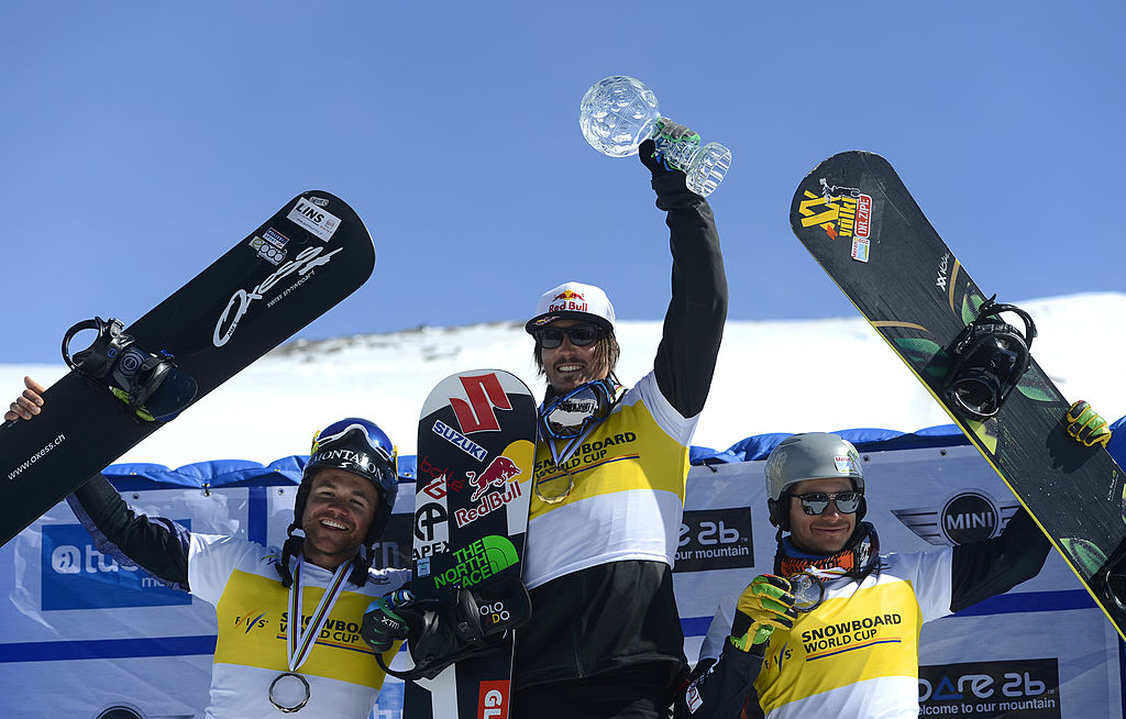 Winner Australian snowboarder Alex Pullin (C) and second-placed Austrian snowboarder Markus Schairer (L) and third-placed medalist Italian snowboarder Omar Visenti (R) celebrate on the podium of the Men's overall Snowboard Cross competition during the Snowboard and FreeStyle World Cup at Sierra Nevada ski resort near Granada on March 21, 2013. AFP PHOTO / PIERRE-PHILIPPE MARCOU (Photo credit should read PIERRE-PHILIPPE MARCOU/AFP via Getty Images)