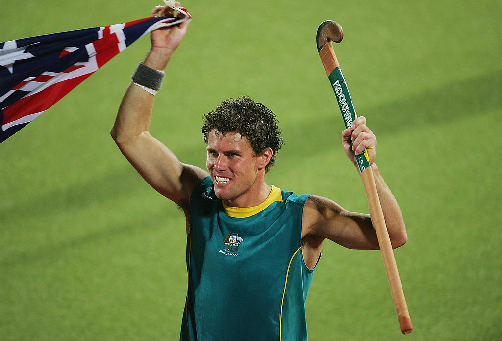 ATHENS - AUGUST 27: Brent Livermore #25 of Australia celebrates winning gold in the men's field hockey gold medal match against the Netherlands on August 27, 2004 during the Athens 2004 Summer Olympic Games at the Helliniko Olympic Complex Hockey Centre in Athens, Greece. (Photo by Stuart Franklin/Getty Images)
