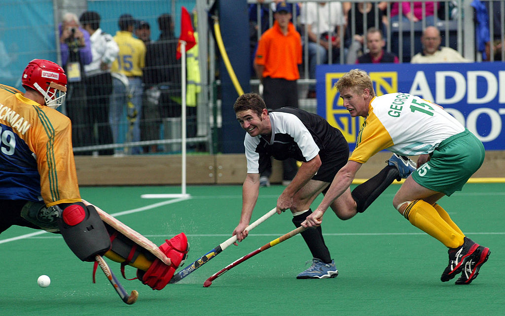 NEW ZEALAND - AUGUST 05: New Zealand Phillips Burrows shots to score around the Australian goal keeper Mark Hickman as Bevan George looks on during the mens Hockey final between New Zealand and Australia played at Bell Vue , during the XVII Commonwealth Games, Sunday. Australia won 52 to take the gold and New Zealand recieved the silver. (Photo by Michael Bradley/Getty Images)