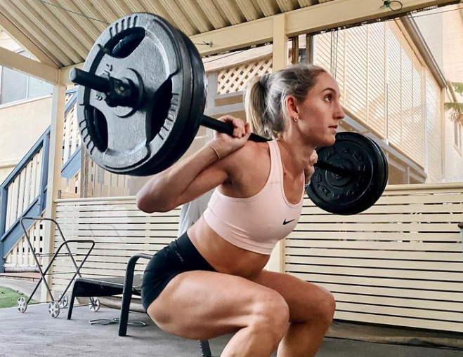 Olympian Sarah Carli lifts weights as part of training.